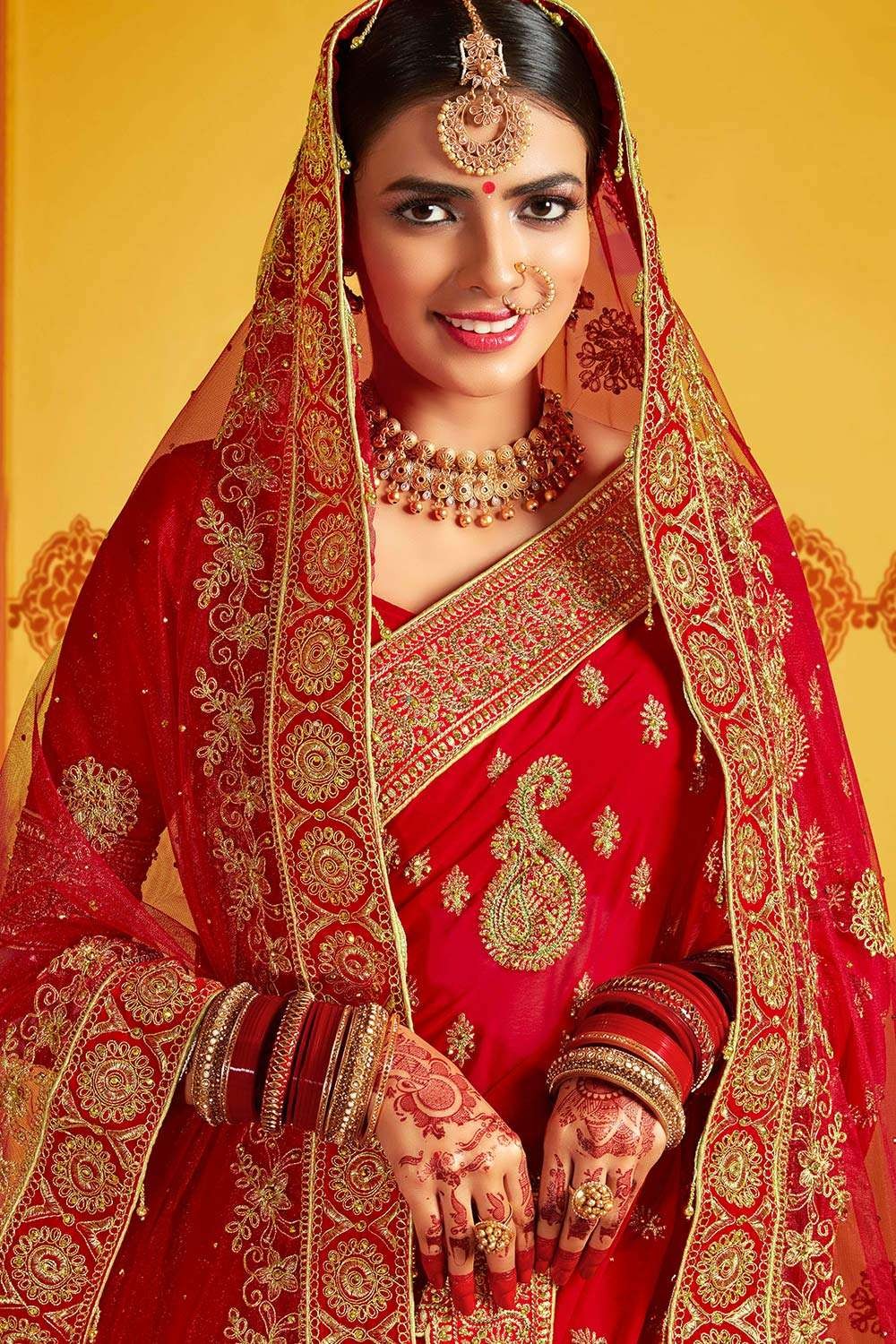 Photo of Beautiful north Indian bride looking stunning in red bridal  lehenga.