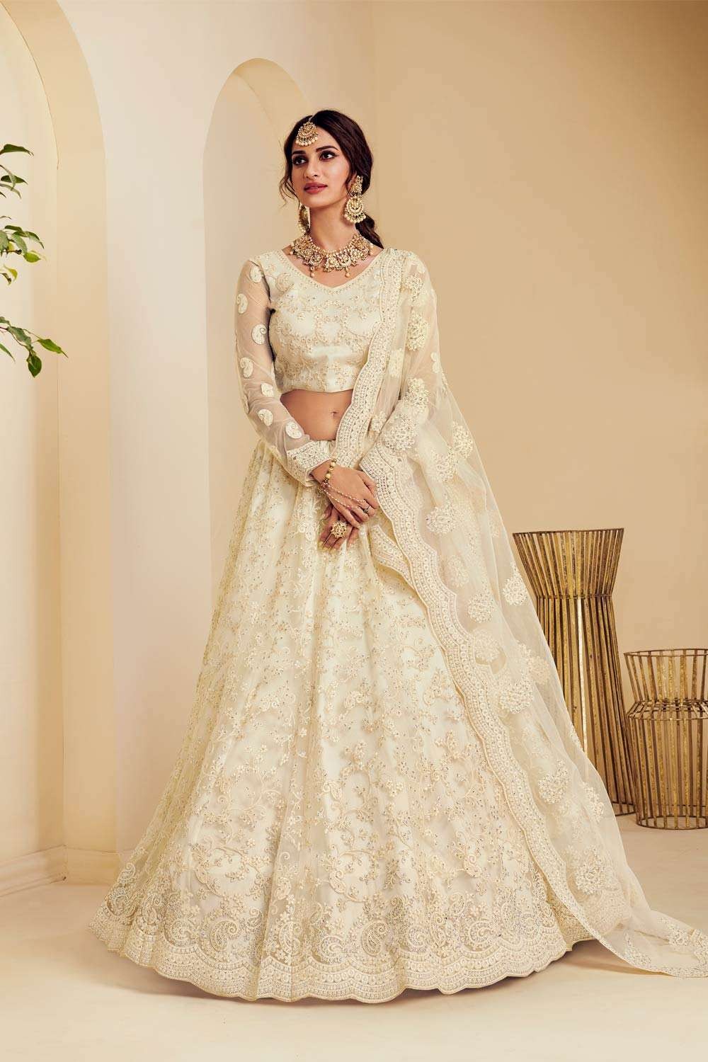 Photo of Bride in a white and golden lehenga